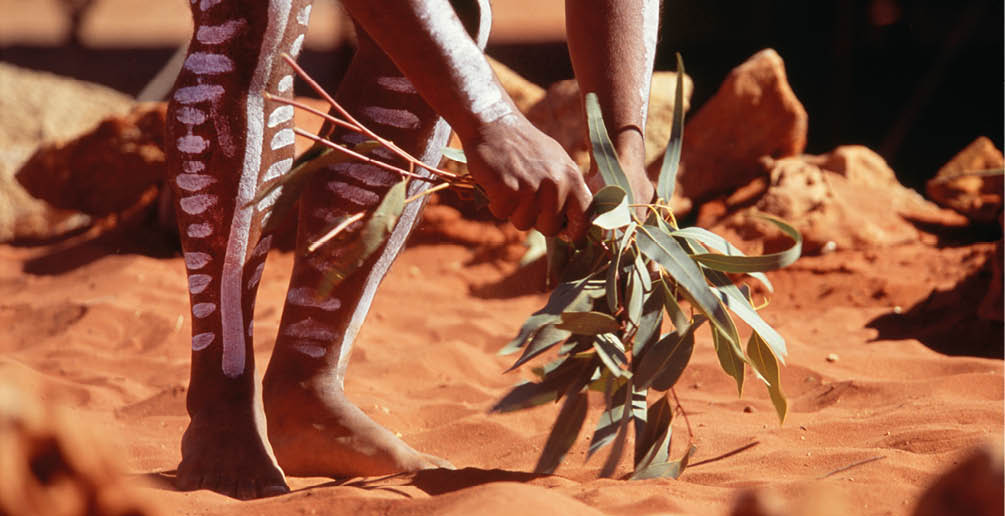 A man of the First peoples of Australia performing a ritual medicine dance.